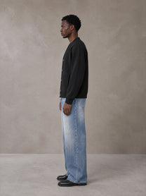 Model wearing SM Sig. Cardigan in Midnight Black, side view.