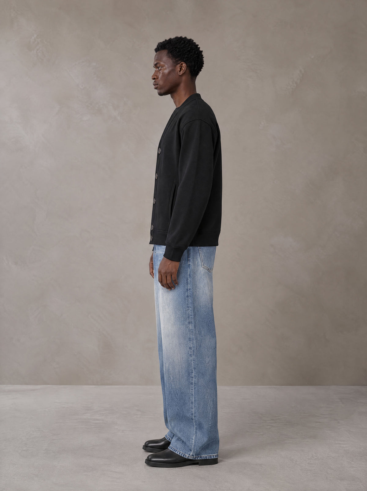 Model wearing SM Sig. Cardigan in Midnight Black, side view.