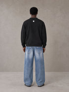 Model wearing SM Sig. Cardigan in Midnight Black, rear view.