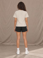 Model wearing SM Motion Stride Shorts in Midnight Black, rear view.