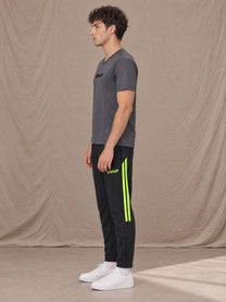 Model wearing SM Motion Stripe Track Trousers in Midnight Black, side view.