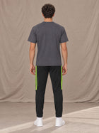 Model wearing SM Motion Stripe Track Trousers in Midnight Black, rear view.