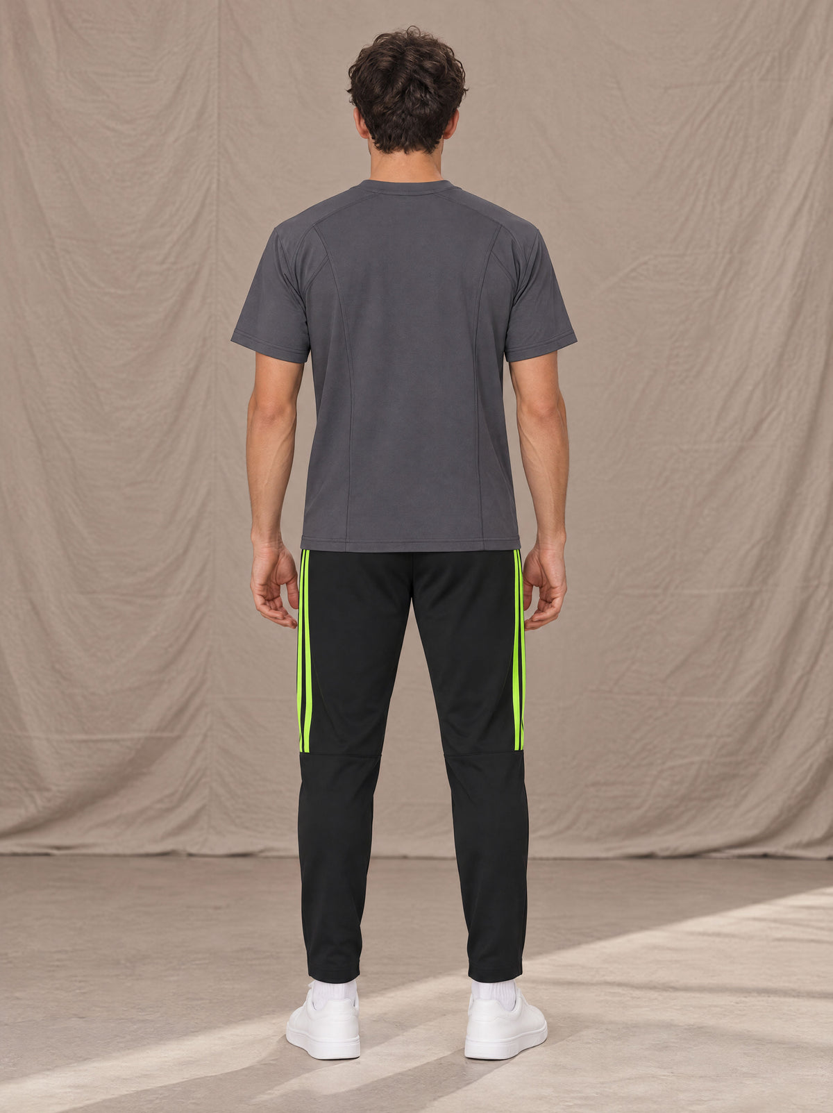 Model wearing SM Motion Stripe Track Trousers in Midnight Black, rear view.