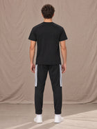 Model wearing SM Motion Stripe Track Trousers in Midnight Black, rear view.
