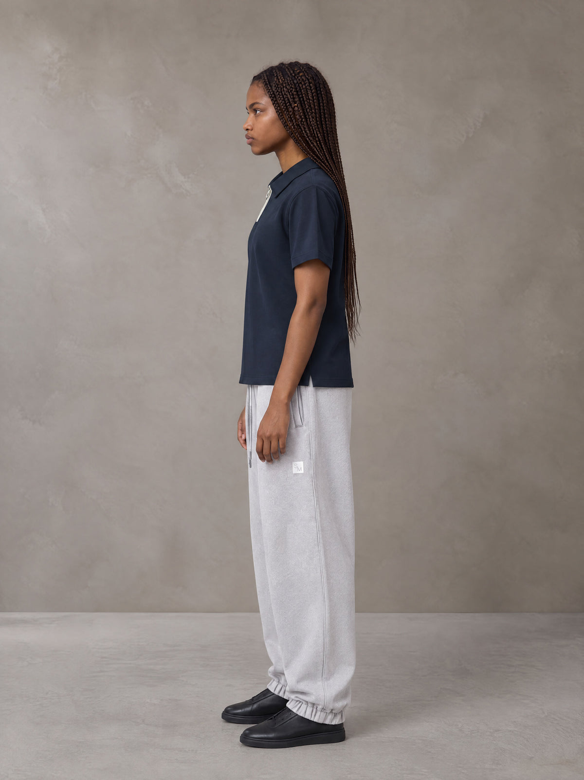 Model wearing SM Sig. Jogger Sweatpants in Floral Grey, side view.