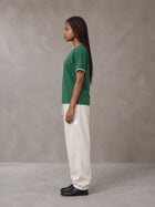 Model wearing SM Sig. Jogger Sweatpants in Oat Grey, side view.