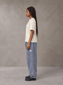 Model wearing SM Sig. Jogger Sweatpants in Washed Blue Jean, side view.