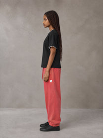 Model wearing SM Sig. Jogger Sweatpants in Watermelon Tint, side view.