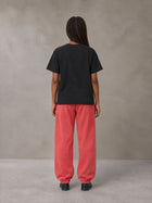 Model wearing SM Sig. Jogger Sweatpants in Watermelon Tint, rear view.