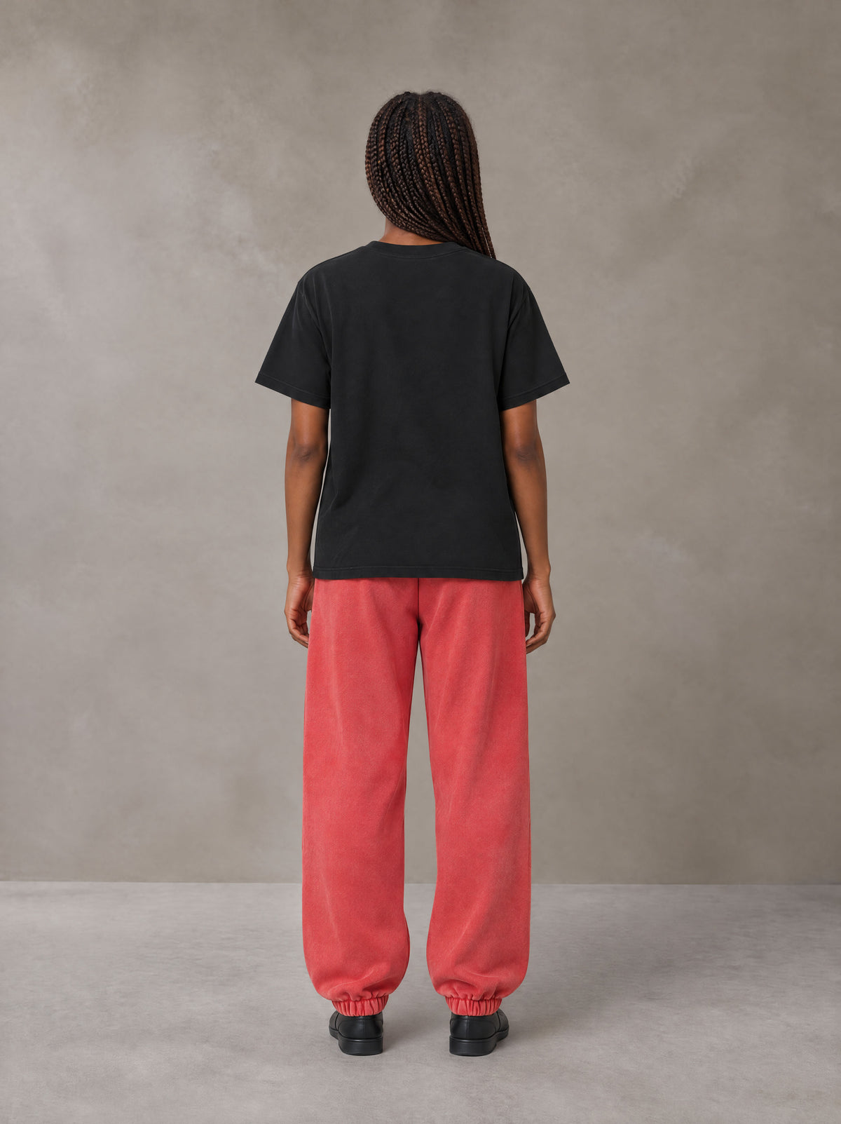 Model wearing SM Sig. Jogger Sweatpants in Watermelon Tint, rear view.