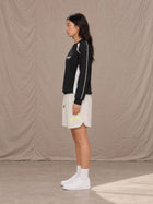 Model wearing SM Motion Sweatshirt in Midnight Black, side view.