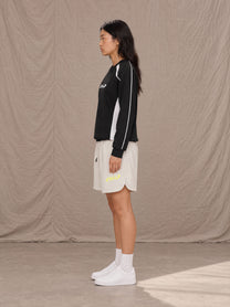 Model wearing SM Motion Sweatshirt in Midnight Black, side view.