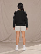 Model wearing SM Motion Sweatshirt in Midnight Black, rear view.