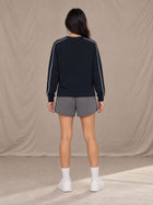 Model wearing SM Motion Sweatshirt in Oxford Navy, rear view.