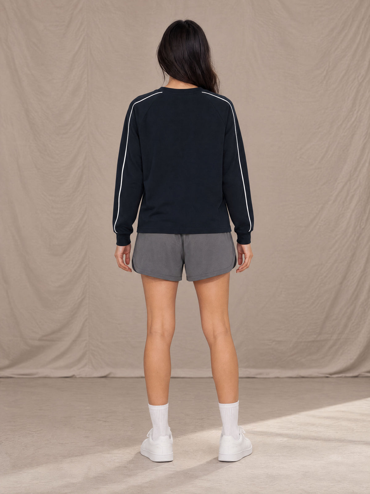 Model wearing SM Motion Sweatshirt in Oxford Navy, rear view.