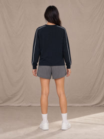 Model wearing SM Motion Sweatshirt in Oxford Navy, rear view.