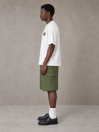 Model wearing SM Verdant Fleur T-shirt in Lucent White, side view.