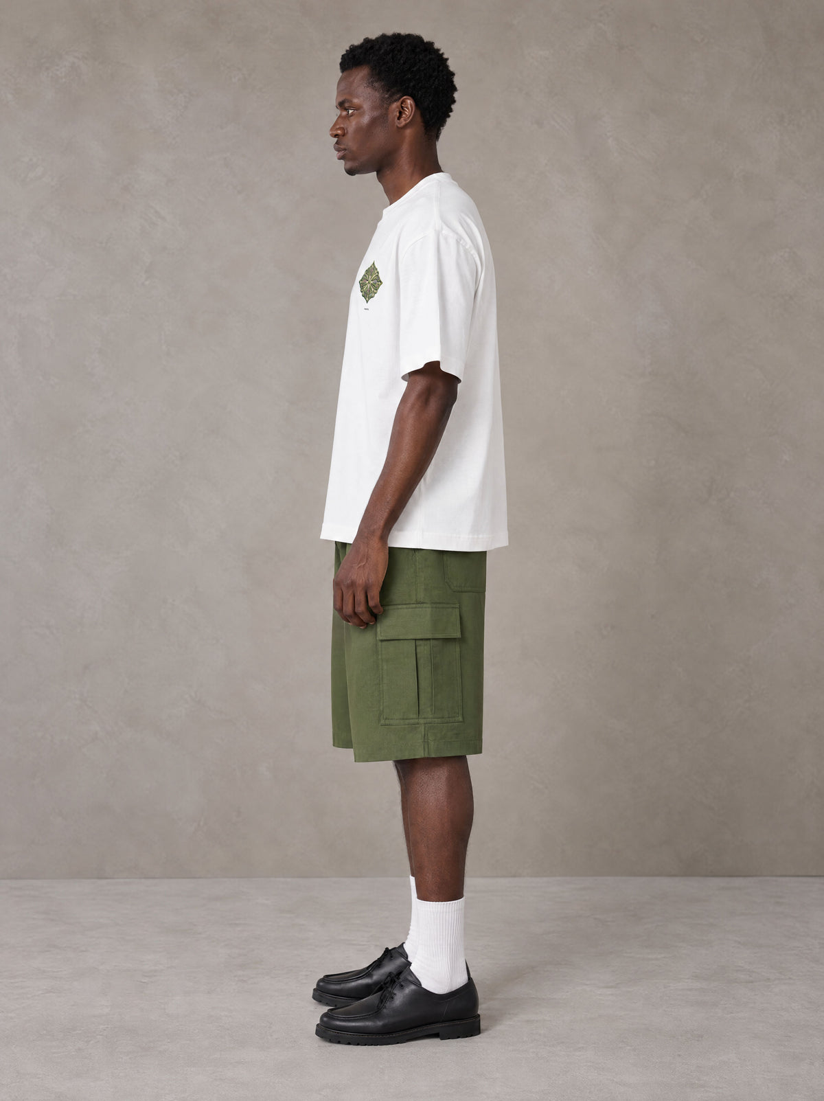 Model wearing SM Verdant Fleur T-shirt in Lucent White, side view.
