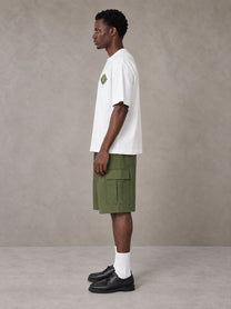 Model wearing SM Verdant Fleur T-shirt in Lucent White, side view.