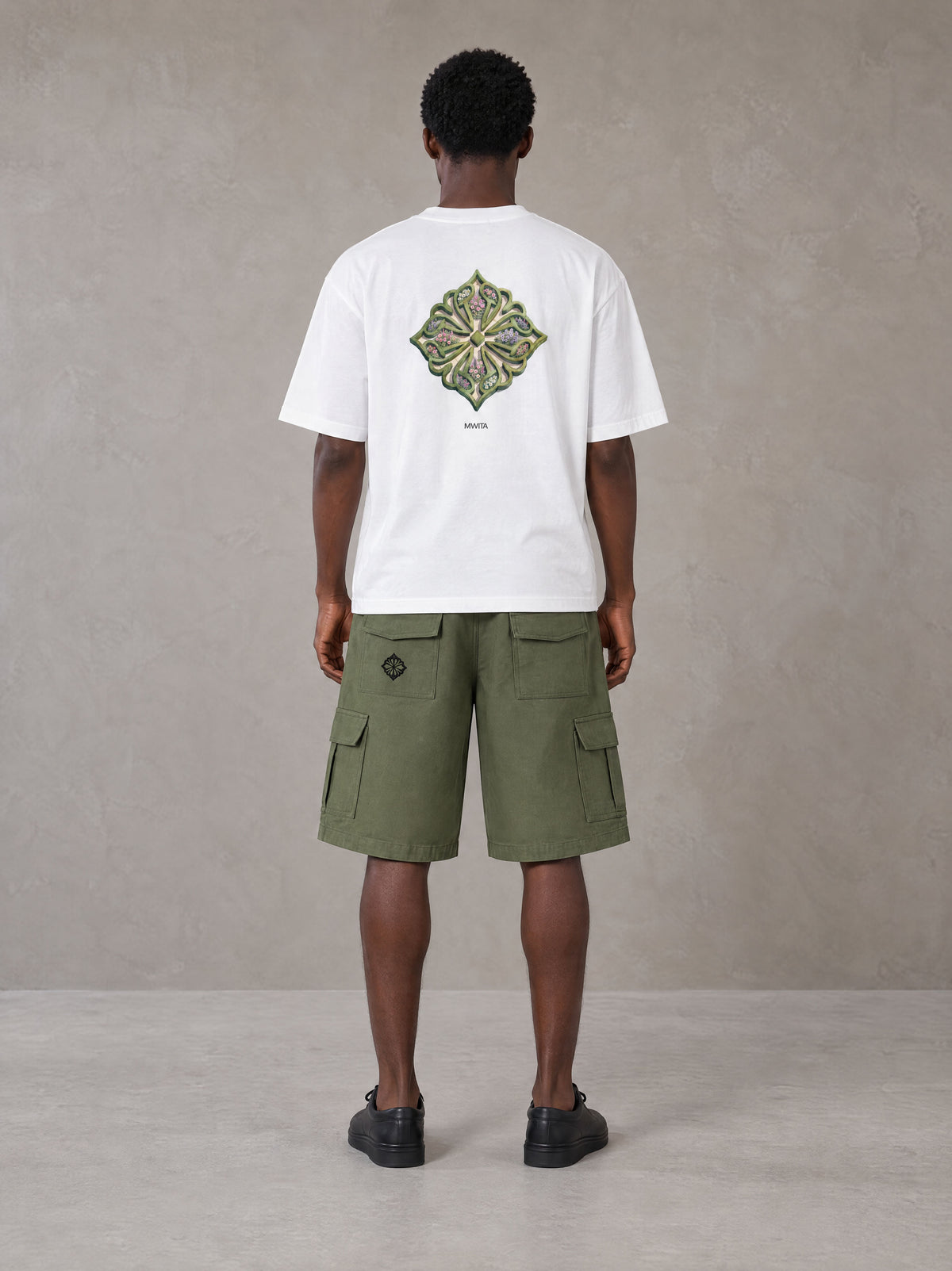 Model wearing SM Verdant Fleur T-shirt in Lucent White, rear view.