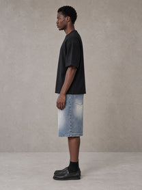 Model wearing SM Heritage Vintage Wash Denim Shorts in Cadet Grey, side view.