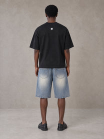Model wearing SM Heritage Vintage Wash Denim Shorts in Cadet Grey, rear view.