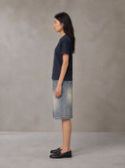 Model wearing SM Sunwash T-shirt in Oxford Navy, side view.