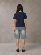 Model wearing SM Sunwash T-shirt in Oxford Navy, rear view.
