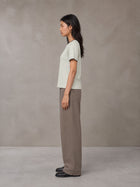 Model wearing SM Sunwash T-shirt in Moon Mist, side view.