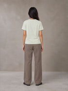 Model wearing SM Sunwash T-shirt in Moon Mist, rear view.