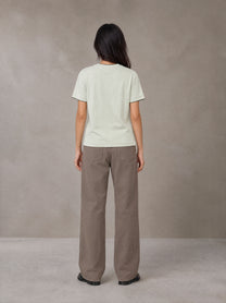 Model wearing SM Sunwash T-shirt in Moon Mist, rear view.