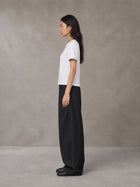 Model wearing SM Sunwash T-shirt in Lucent White, side view.