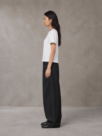 Model wearing SM Sunwash T-shirt in Lucent White, side view.