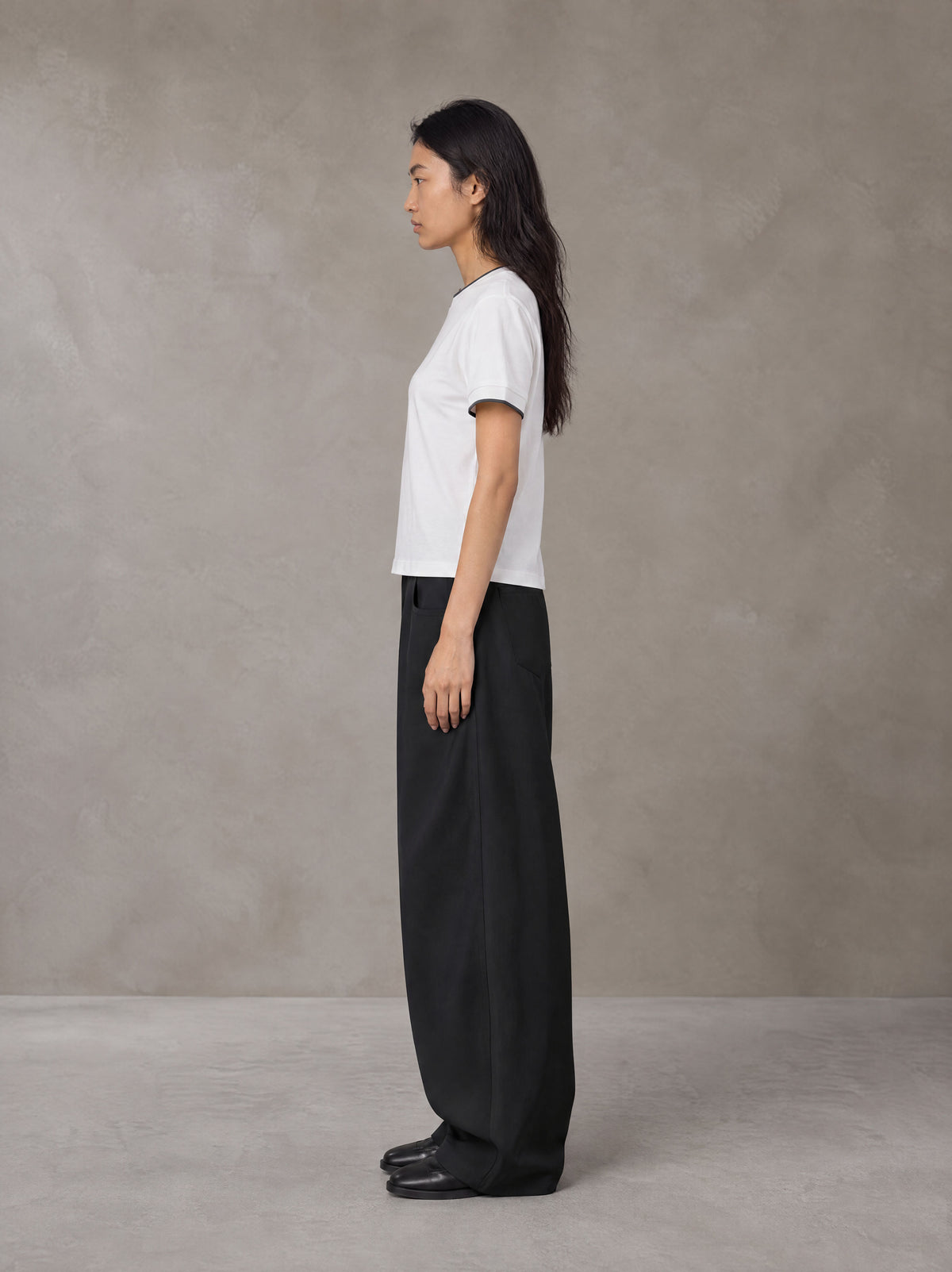 Model wearing SM Sunwash T-shirt in Lucent White, side view.
