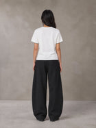 Model wearing SM Sunwash T-shirt in Lucent White, rear view.
