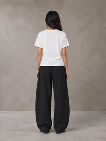 Model wearing SM Sunwash T-shirt in Lucent White, rear view.