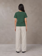 Model wearing SM Sunwash T-shirt in Dark Spring Green, rear view.