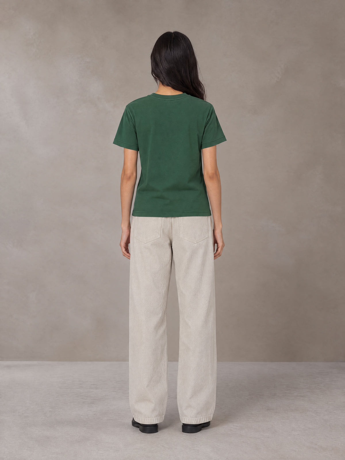 Model wearing SM Sunwash T-shirt in Dark Spring Green, rear view.