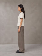 Model wearing SM Sunwash T-shirt in Oat Grey, side view.