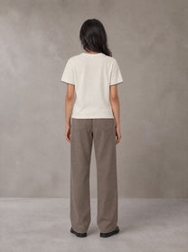 Model wearing SM Sunwash T-shirt in Oat Grey, rear view.