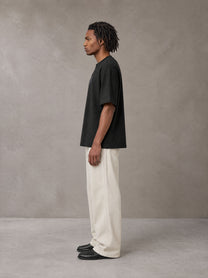 Model wearing SM Still Life NO.01 T-shirt in Midnight Black, side view.