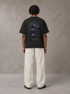 Model wearing SM Still Life NO.01 T-shirt in Midnight Black, rear view.