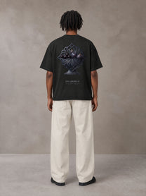 Model wearing SM Still Life NO.01 T-shirt in Midnight Black, rear view.