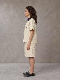 Model wearing SM Eternal Fleur Shirt in Pavlova with SM Eternal Fleur Utility Shorts in Pavlova, side view.