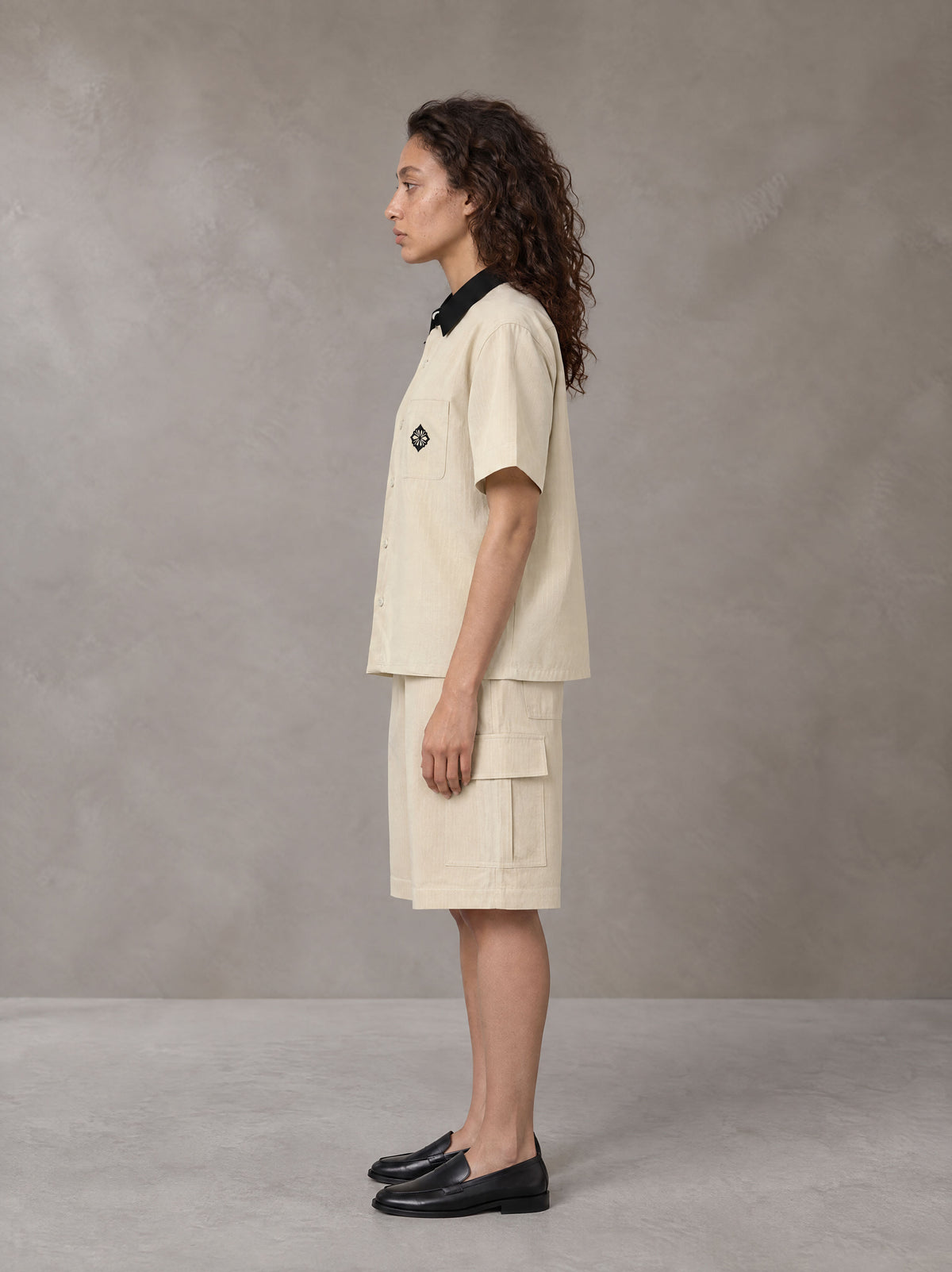 Model wearing SM Eternal Fleur Shirt in Pavlova with SM Eternal Fleur Utility Shorts in Pavlova, side view.