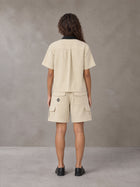 Model wearing SM Eternal Fleur Shirt in Pavlova with SM Eternal Fleur Utility Shorts in Pavlova, rear view.