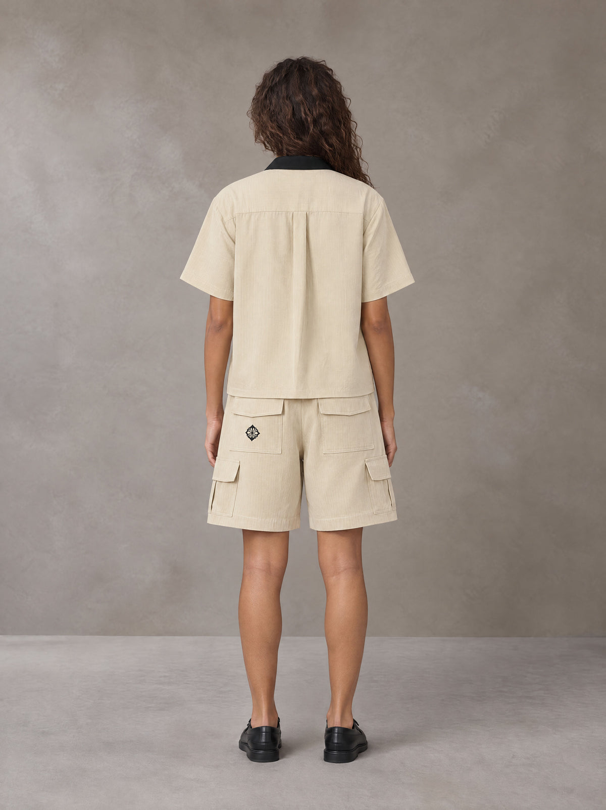 Model wearing SM Eternal Fleur Shirt in Pavlova with SM Eternal Fleur Utility Shorts in Pavlova, rear view.