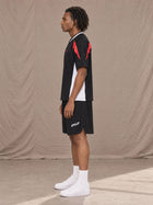 Model wearing SM Motion Vector Jersey in Midnight Black, side view.