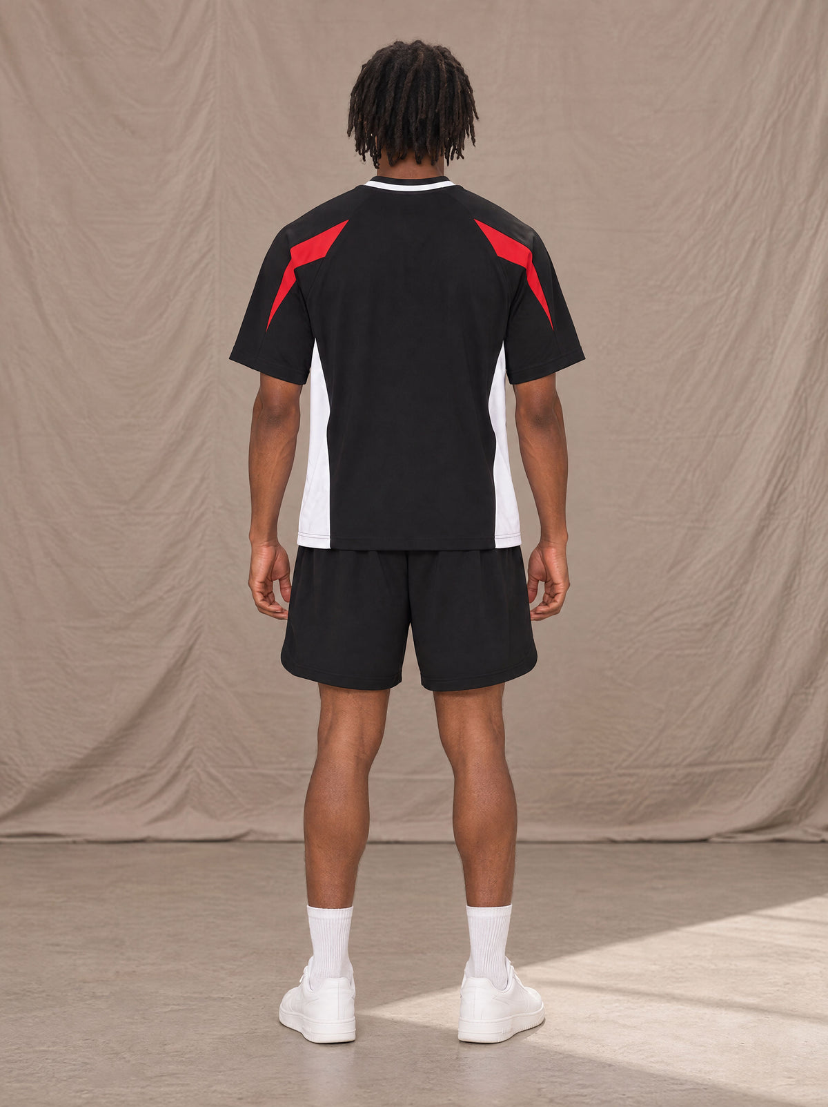Model wearing SM Motion Vector Jersey in Midnight Black, rear view.