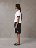 Model wearing SM Plaid Shorts in Midnight Black, side view.
